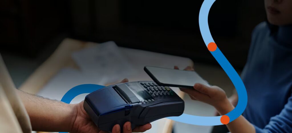 Person making a contactless payment using a smartphone and a card reader